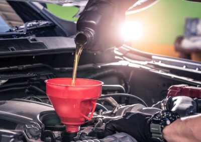 the close up image of the technician filling a new lubricant in