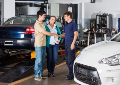 Mechanic Shaking Hand With Couple